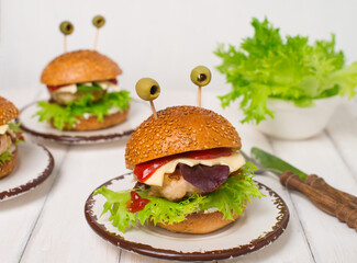 Haloween monster burgers for halloween on wood. Fun food art for kids.