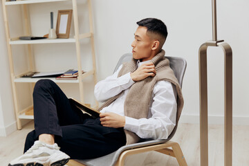 teenager in the room with the tablet in the chair rest Lifestyle