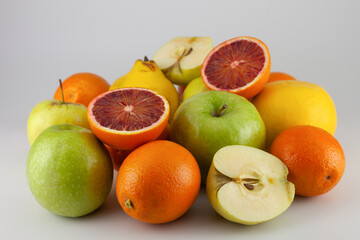 various fruits on a white background. Apple, orange, quince, grapefruit