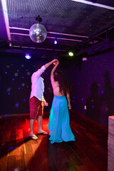 couple dancing waltz in nightclub
