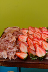 close-up of slices of ham and strawberries, strawberries and parma ham