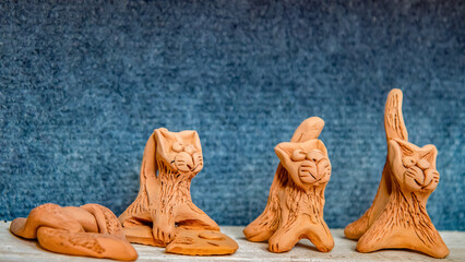clay figures. artisan pottery workshop. cats