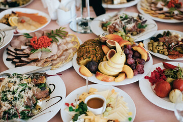 Different food on a plate at a holiday party. Table setting