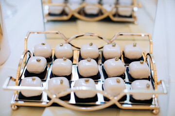 Wedding desserts. Cakes in sweet icing on the table in a restaurant