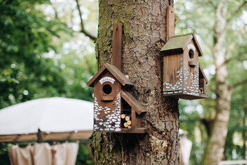 Birdhouse in the garden on a tree. Decor for the garden