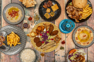 Asian food and kebab dishes set, basmati rice, falafel, durum, hummus with paprika, cheese rolls, cardamom, iranian croquettes, kebab sandwich