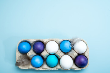 Multi-colored Easter eggs in an egg tray