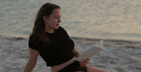 Woman relaxes at the beach of Miami at sunset - beautiful silhouette shot