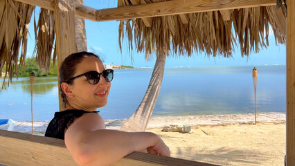 Young woman relaxing at a Caribbean beach - travel photography