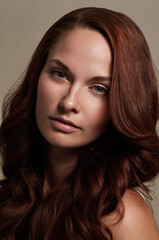 Naklejka premium Shes a fiery beauty. Closeup portrait of an attractive young woman in studio.