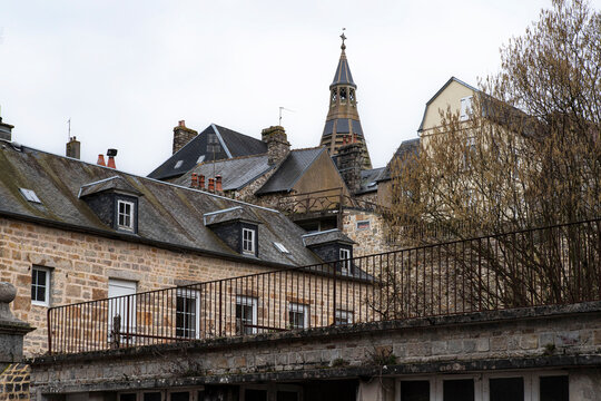 Architecture of a town in Normandy with a church tower and old houses