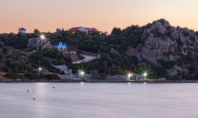 The landscape with rocky hill, small chapel, windmill and calm water, Greece