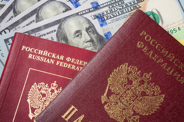 Russia Sanctions and Ukraine war concept. Russian Federation passports on american dollars. Currency ban in Russia