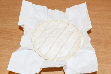 Camembert cheese in wrapping paper