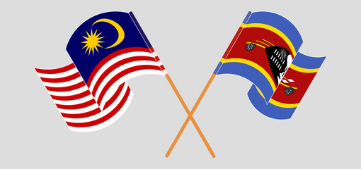 Crossed and waving flags of Malaysia and Eswatini