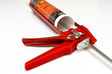 red caulk gun isolated on white background