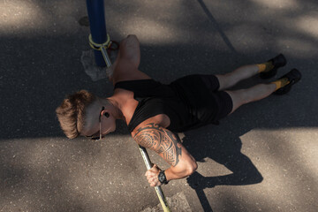 Strength and motivation. Top view of young handsome man in sportswear doing push-up on the street