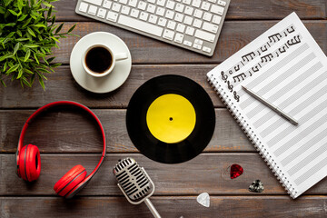 Music education with music sheets and headphones, top view