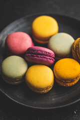 Sweet colorful macarons. Traditional french macaroons. Tasty dessert on plate.