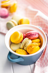 Sweet colorful macarons. Traditional french macaroons. Tasty dessert in pot.