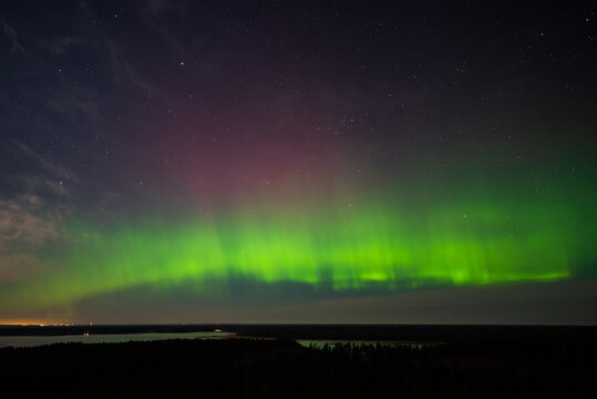 Aurora borealis, The Northern lights at the lake Usma and forest, Latvia. Aerial view.