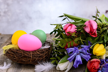 Easter eggs in nest and miscellaneous flowers