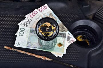  Polish money currency and the thick, greasy yellow motor oil under oil cap