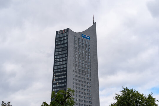 LEIPZIG, GERMANY - 19. September 2021: Huge skyscraper in the city. High rise building in front of a covered sky. Grey facade with the MDR logo. Big tower in the town with modern architecture.