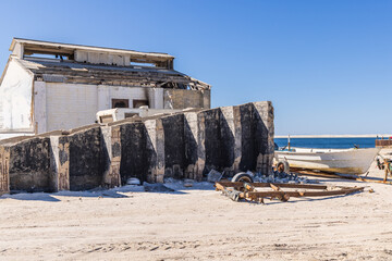Boats and out buildings at an abandoned lighthouse on the western coast of the Baja peninsula.