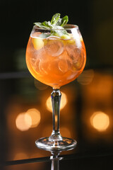 Alcohol orange cocktail drink on blur green background