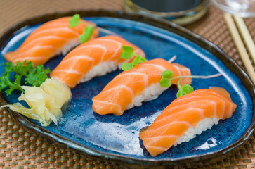 Delicious premium salmon nigiri on blue plate