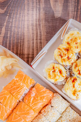 Japanese food rolls in paper boxes. Food delivery.