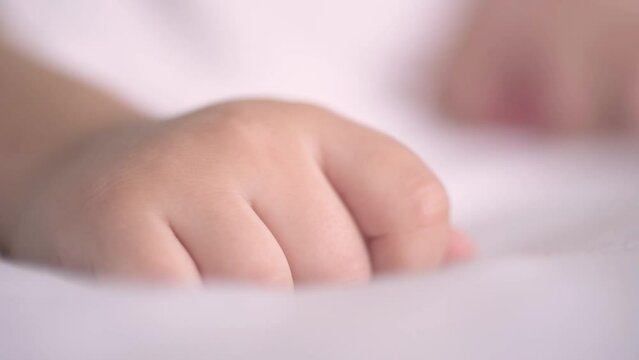 Peaceful baby boy sleeping on bed. Two years old toddler sleeping alone. 