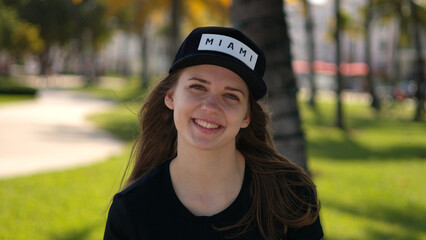 Close up shot of a pretty girl under palm trees at the beach