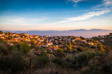 sunset over the mountains and village