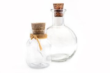 two glass vials with stoppers on white background.