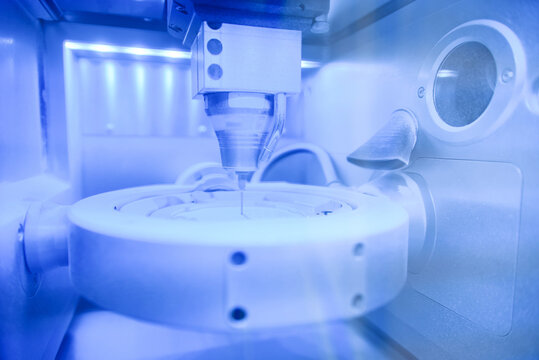 Cad cam milling machine in dental laboratory. Production of high esthetic dental crowns and dentures.