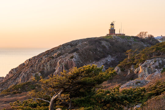Lighthouse during golden hour at Kullaberg Peninsula (Nature reserve) in Sweden. Popular tourist destination for hiking.