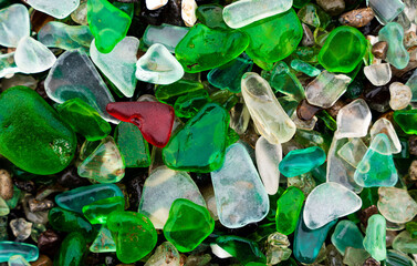 Glass Bay in Vladivostok. Sea-polished colored glass on the beach. Background, texture