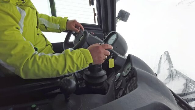 Pov drive of snowplow ratrack machine during skier, mountaineer, hiker, rescue mission on peak at snow storm