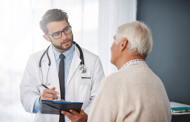 Lets set up an appointment for next week. Cropped shot of a young male doctor going through medical records with his senior male patient.