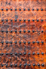 Ancient run-down copper door texture background