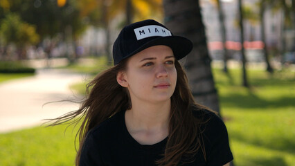 Close up shot of a pretty girl under palm trees at the beach