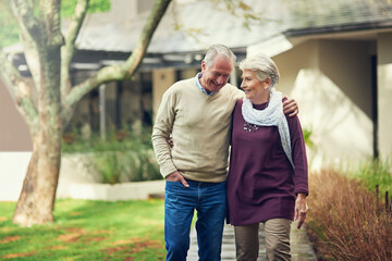 Joyful moments. Shot of a loving senior couple taking a walk outside.