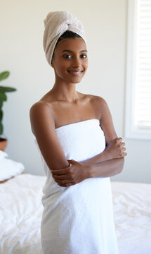 I feel so refreshed. Cropped portrait of an attractive young woman wrapped in a towel while standing with her arms folded in the bedroom.