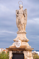 Fototapeta na wymiar Statue of Saint Raphael in the middle of the Roman Bridge in Cordoba, Spain.