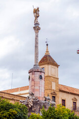 Obraz premium Column and statue commemorating the triumph of Saint Raphael situated in Plaza del Triunfo, Cordoba