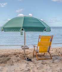A beach umbrella, rental number 28, rented on the beach at Waikiki, in Honolulu, Hawaii.