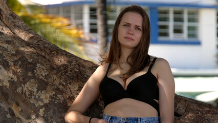 Young pretty woman enjoys the sun of Miami Beach