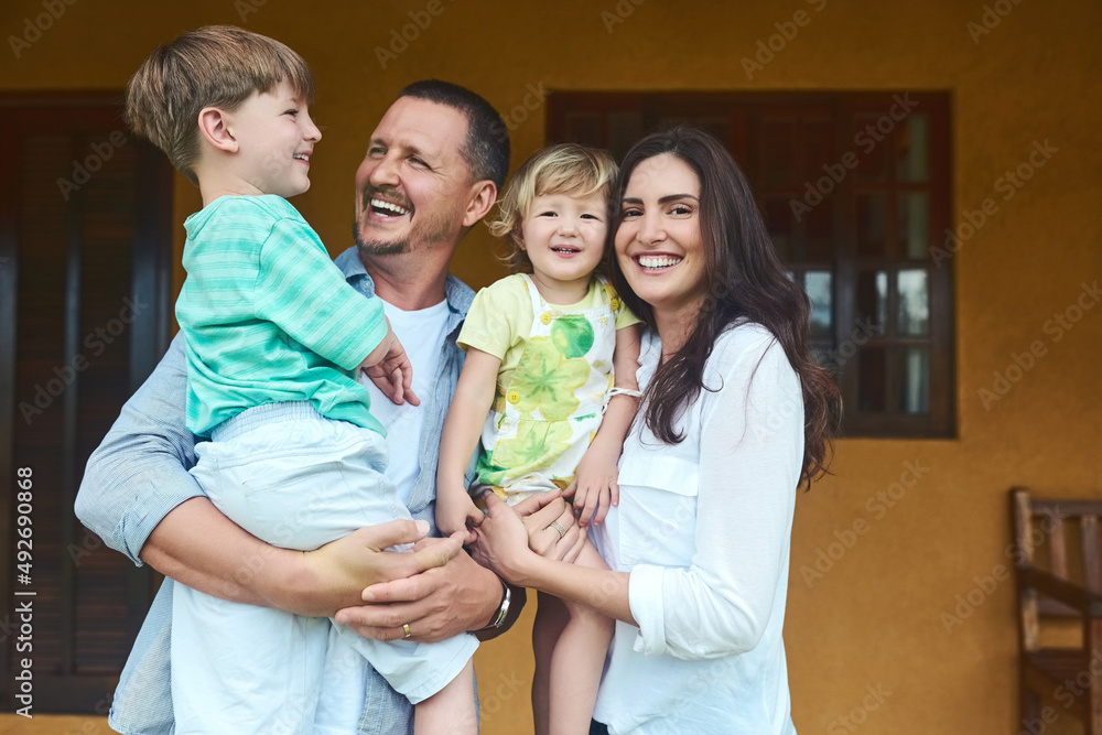 Wall mural Our family is all love, all the time. Portrait of a young happy family spending time together in the backyard at home.